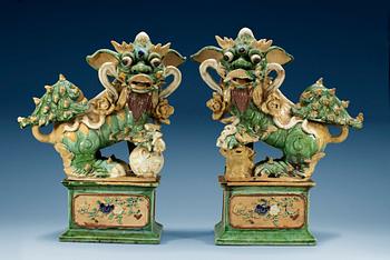 1287. A pair of figures of Buddhist Lions on stands, Qing dynasty (1644-1912). (2).