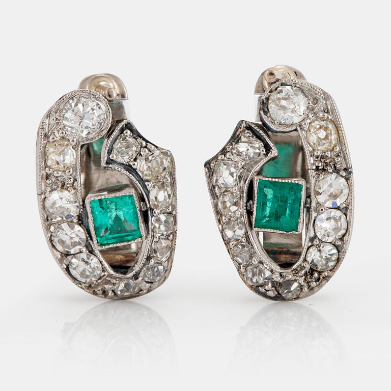 A pair of 18K white gold earrings set with faceted emeralds and old- and eight-cut diamonds.