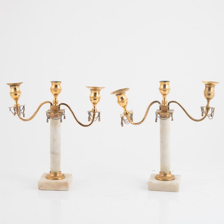 A pair of late Gustavian three-light white marble and gilt brass candelabra, late 18th century.