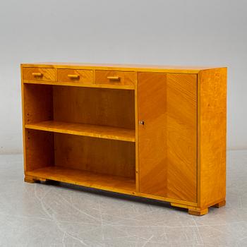 A 1930s birch and elm veneered shelf.