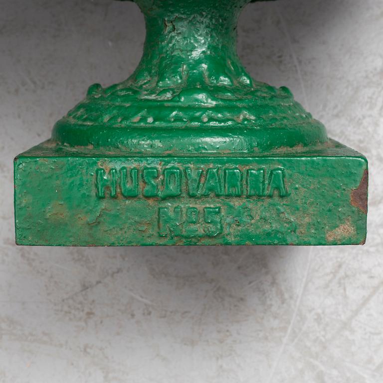 A pair of cast iron garden urns by Husqvarna, circa 1900.