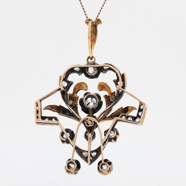 A 14K gold and silver pendant set with old- and rose-cut diamonds.