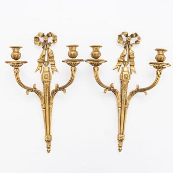 A pair of gilt-bronze Louis XVI-style two-branch appliques, circa 1900.