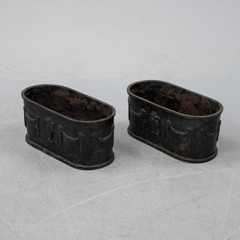 A pair of 20th century cast iron plant pots.