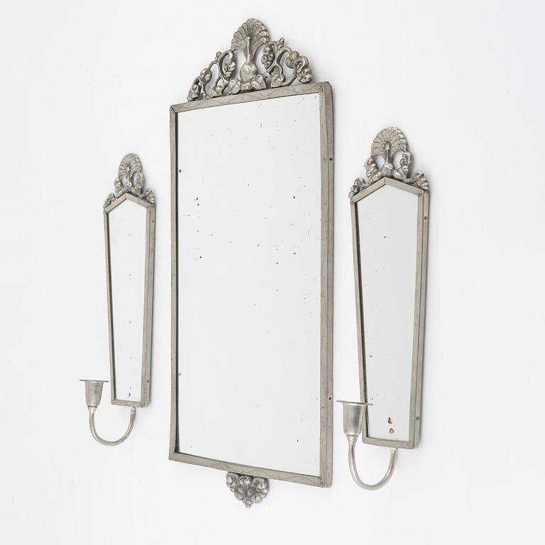 A pewter mirror with a pair of sconces, 1920's/30's.