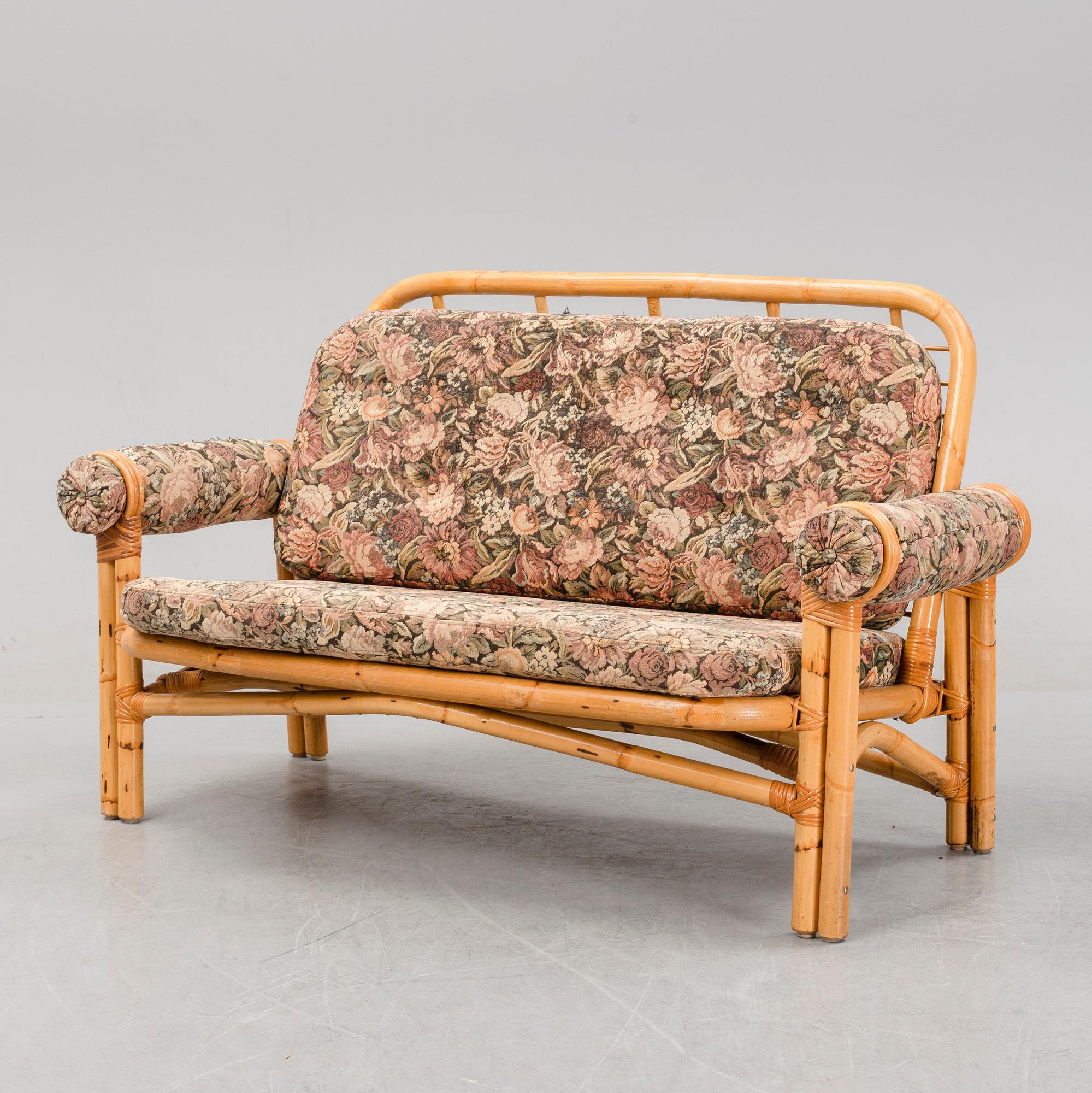 A set of two garden sofas, an armchair and a glass table, later part of the 20th Century.