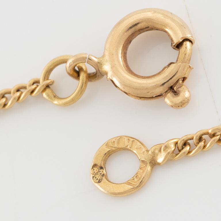 Necklace, 18K gold with synthetic white stone, in the shape of a bow.