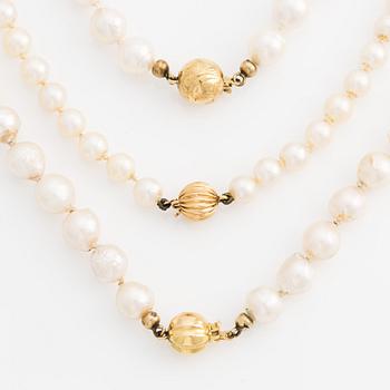 Two necklaces and one bracelet with cultured pearls and 18K gold clasps.