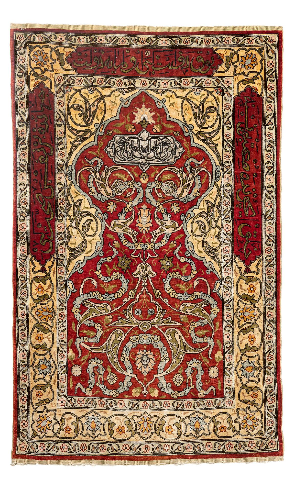 A silk and metal Hereke rug, c. 86 x 52 cm.