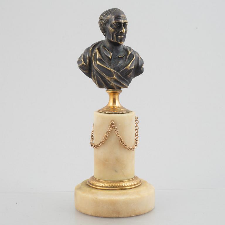 A Louis XVI patinated bronze and marble library bust of Voltaire, late 18th century.