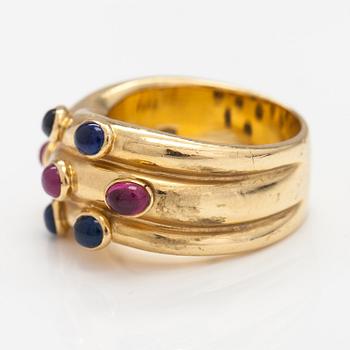 An 18K gold ring with rubies and sapphires. Import marked Torbjörn Tillander, Helsinki 1991.