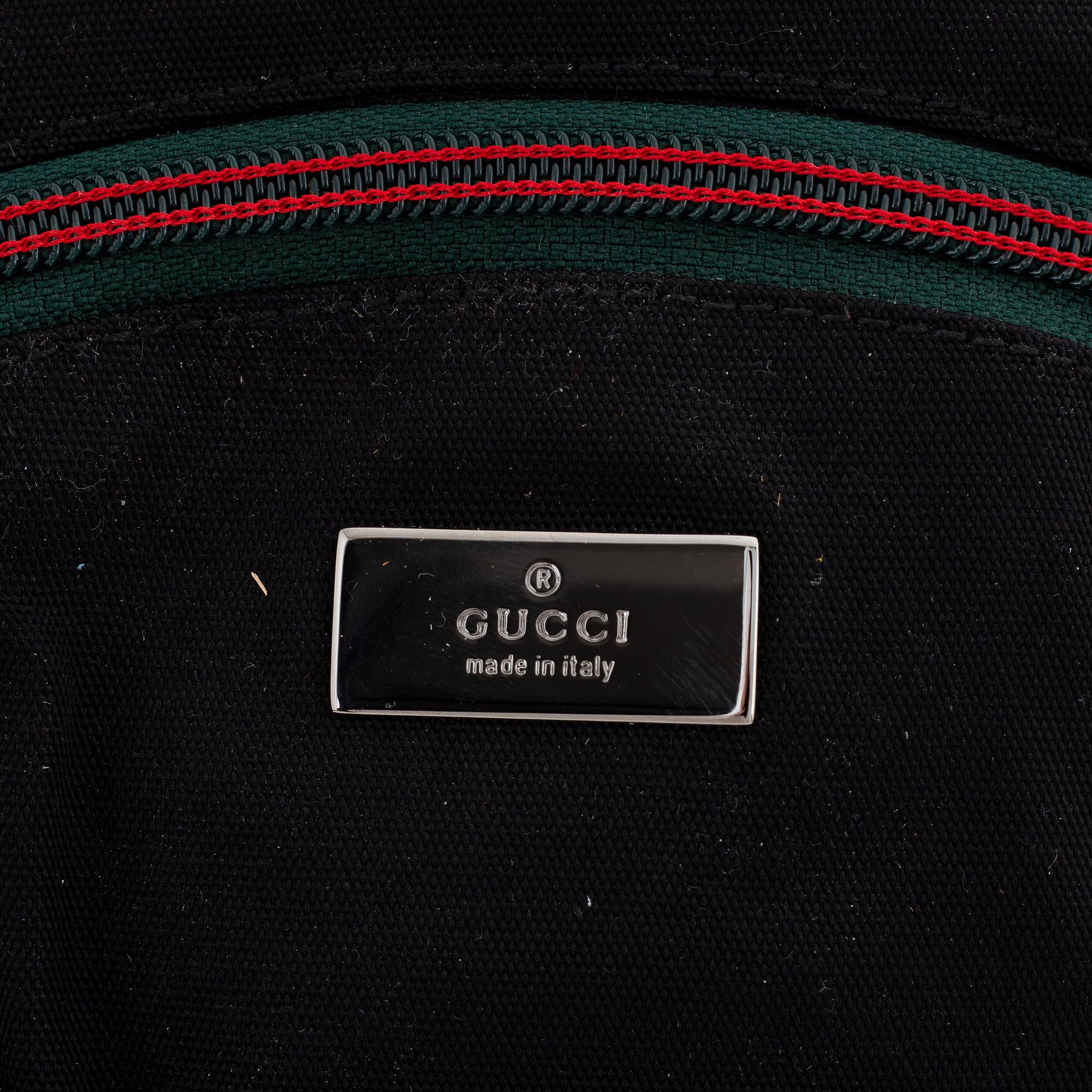 Gucci, a black canvas backpack.