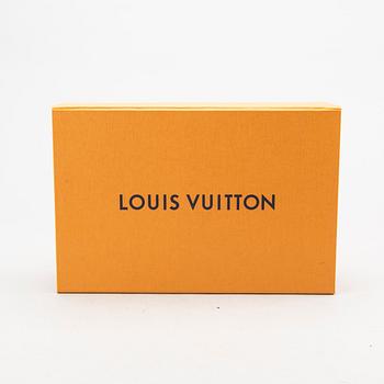 A Louis Vuitton Pallas clutch.