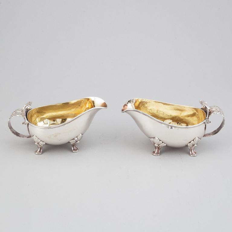 A pair of rococo-style parcel-gilt silver sauce-boats, mark of CGH, Stockholm 1945-1947.