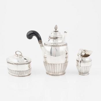 A Swedish silver coffee pot, a sugarbox and a creamer, including Stockholm, 1919.