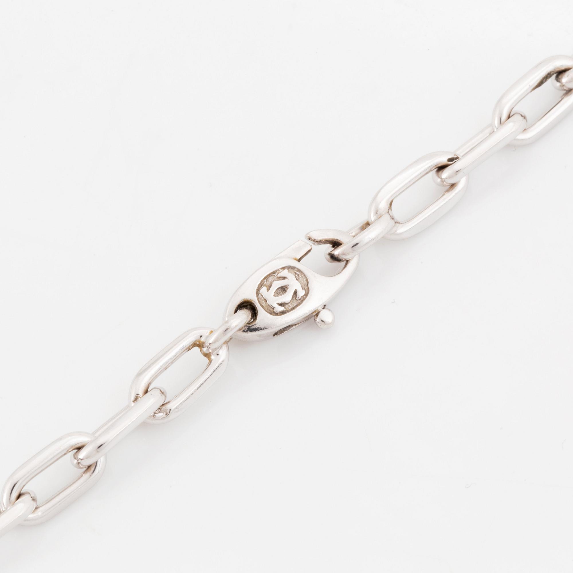 An 18K gold and white gold Cartier necklace with a charm.