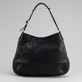 GUCCI, a black leather handbag.