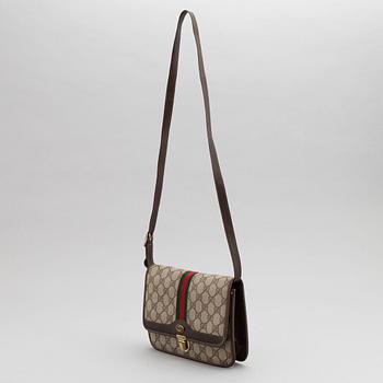 Gucci, a canvas handbag.