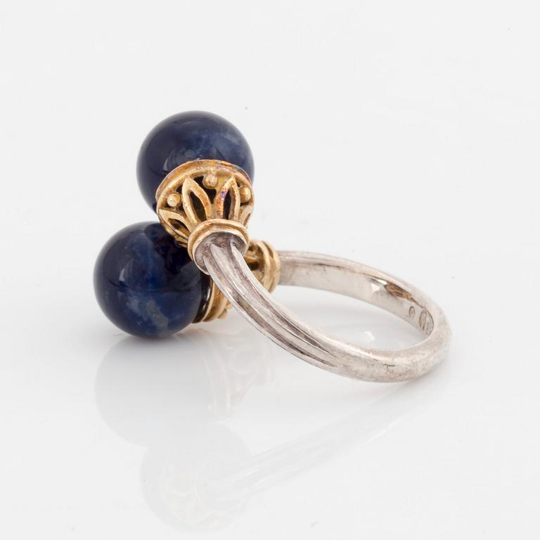 An Ilias Lalaounis demi parure comprising a necklace, a bracelet and a ring in silver and 18K gold set with sodalite.