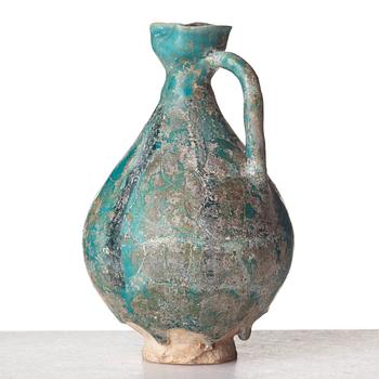 A EWER, pottery, Persia 13th century, probably 
Kashan, height ca 17,5 cm.