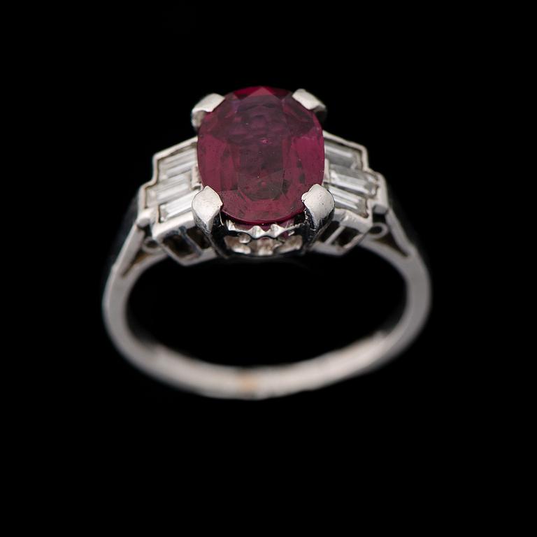 A RING, facetted ruby, baguette cut diamonds, platinum.