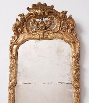 A Swedish rococo giltwood mirror, later part of the 18th century.