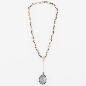 Pendant with silver chain and blue stone, likely moonstone.