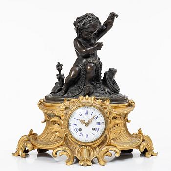 A Rococo style mantle clock and pair of candelabra, France, late 19th Century.