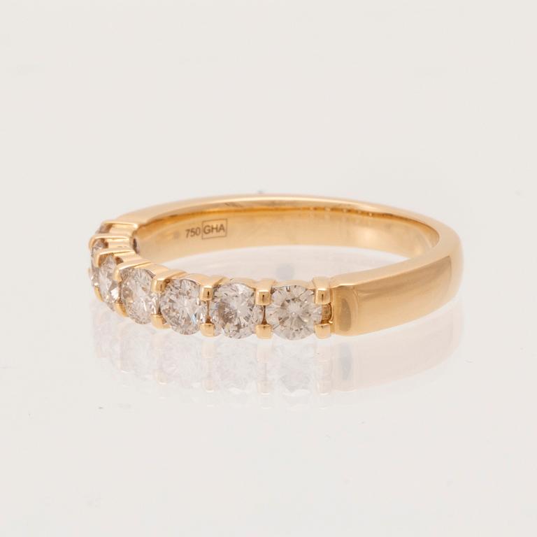 An 18K gold half-eternity ring set with round brilliant-cut diamonds.