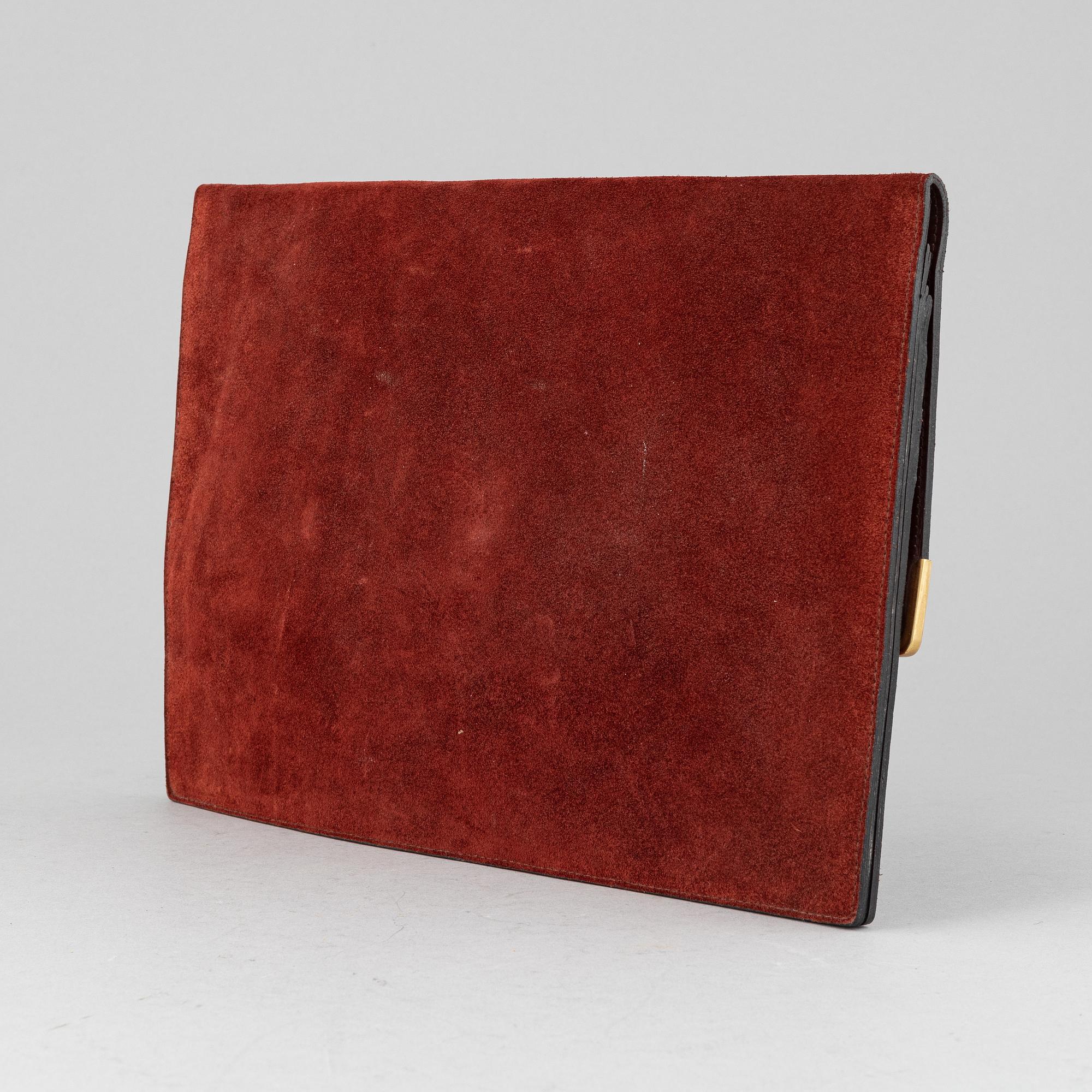 Cartier, a red suede clutch.