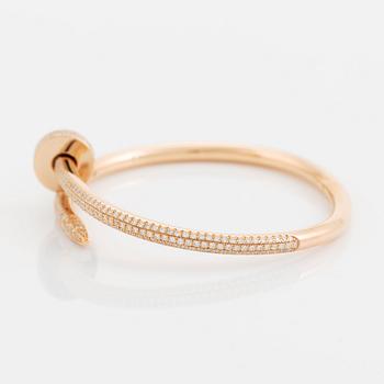 A Cartier "Juste en Clou" bracelet in 18K rose gold set with round brilliant-cut diamonds.