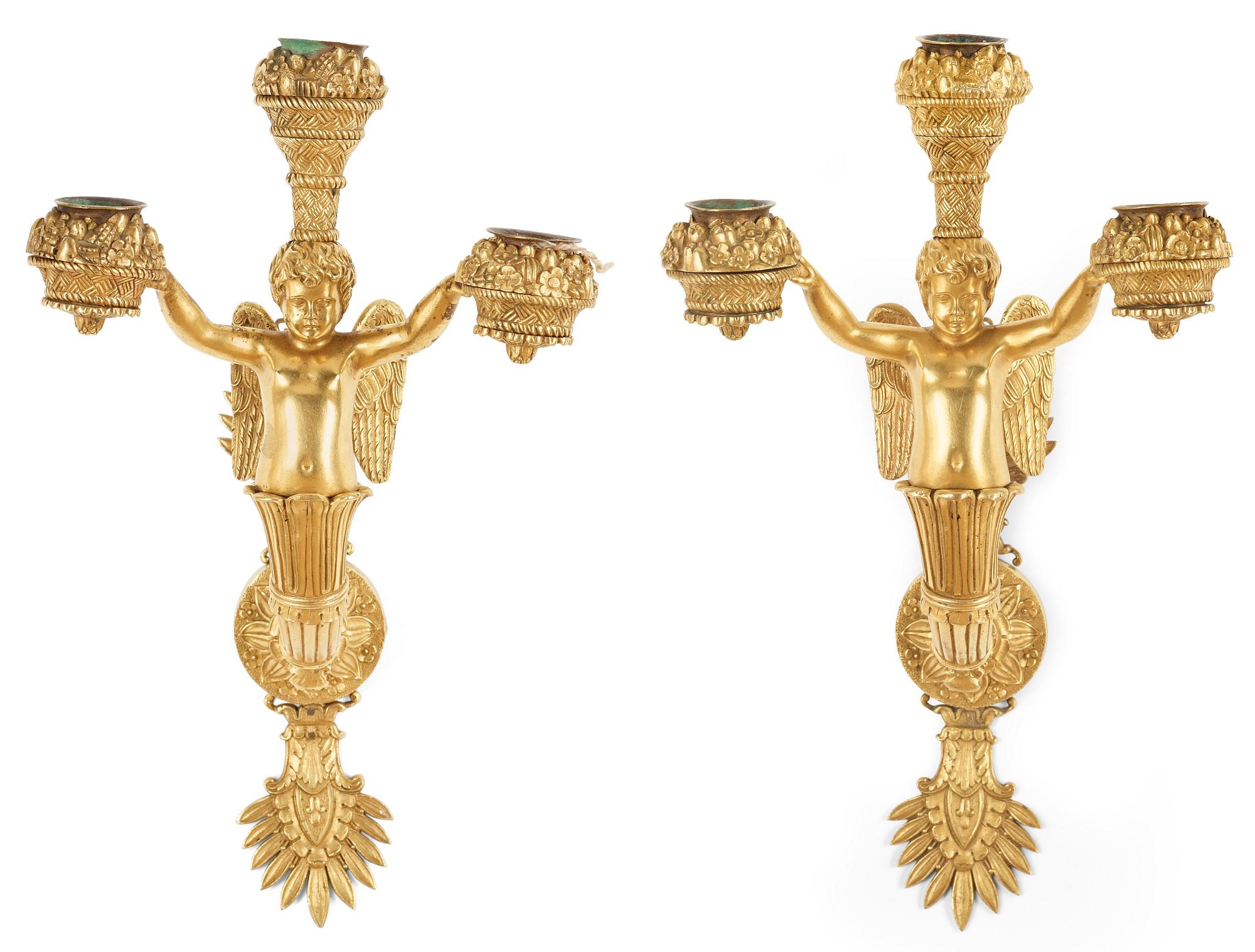 A pair of Empire early 19th century three-light wall-lights.