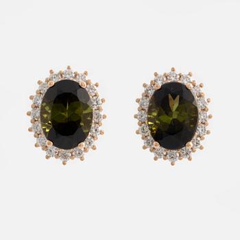 Earrings with green tourmalines and brilliant-cut diamonds.