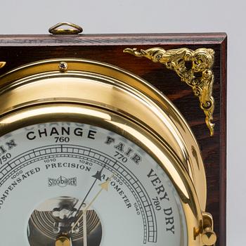 A BRASS MARINE CLOCK AND BAROMETER BY STOCKBURGER.