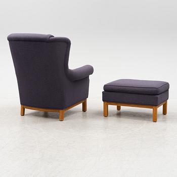 An armchair with foot stool, Norell Möbler AB, Sweden, late 20th century.