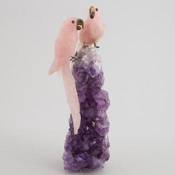 Sculpture, carved stone, birds on a quartz cliff.