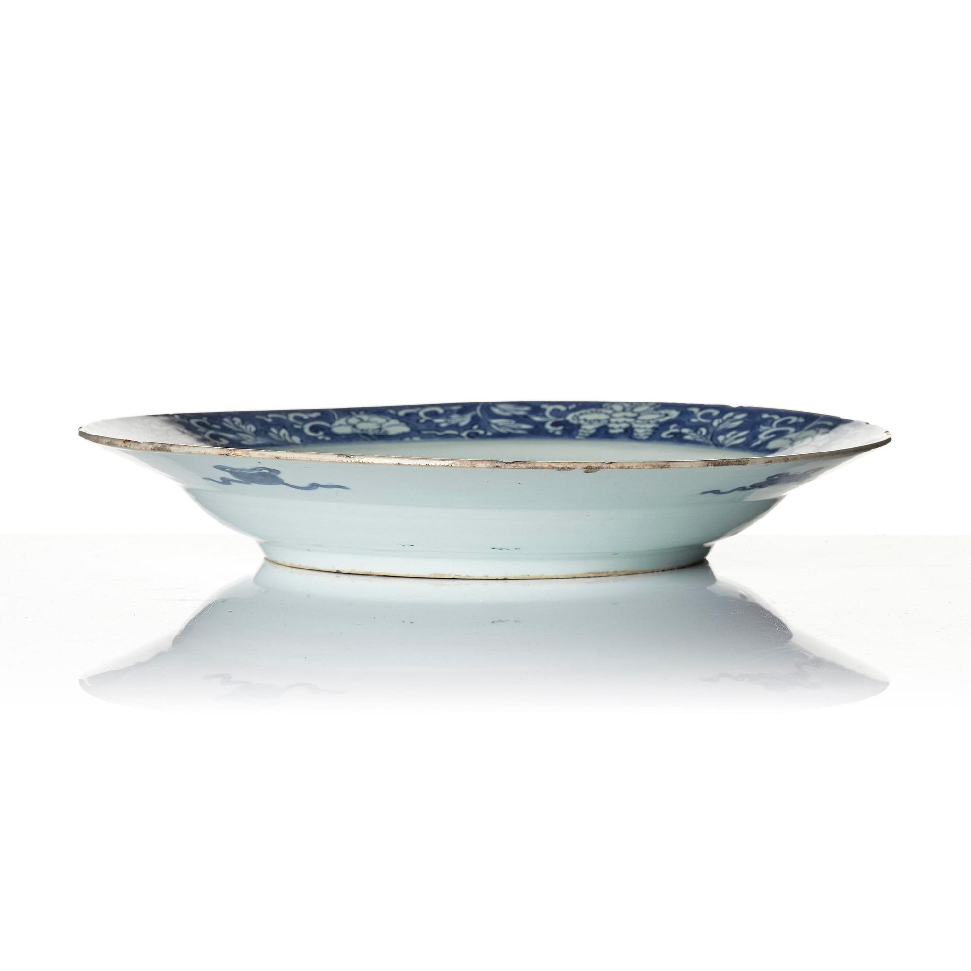A blue and white 'reverse decorated' serving dish, Qing dynasty, Kangxi (1662-1722).
