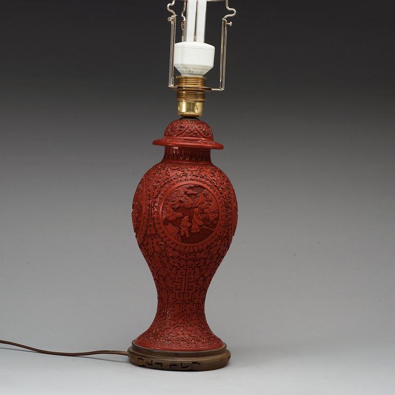 A Chinese red lacquered vase with cover, 20th Century.