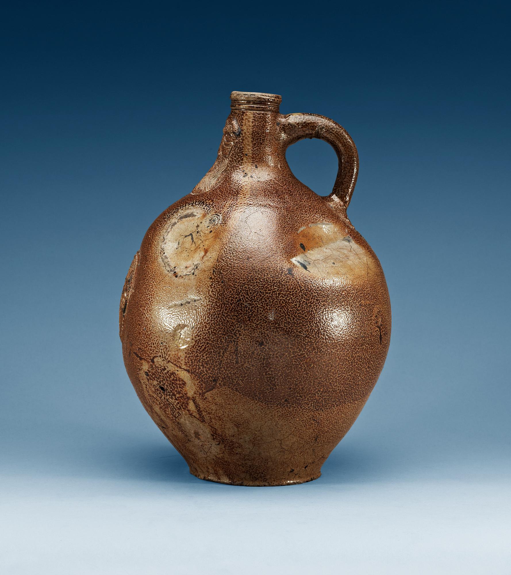 A large salt-glazed stoneware 'Bartman jug', 17th Century.
