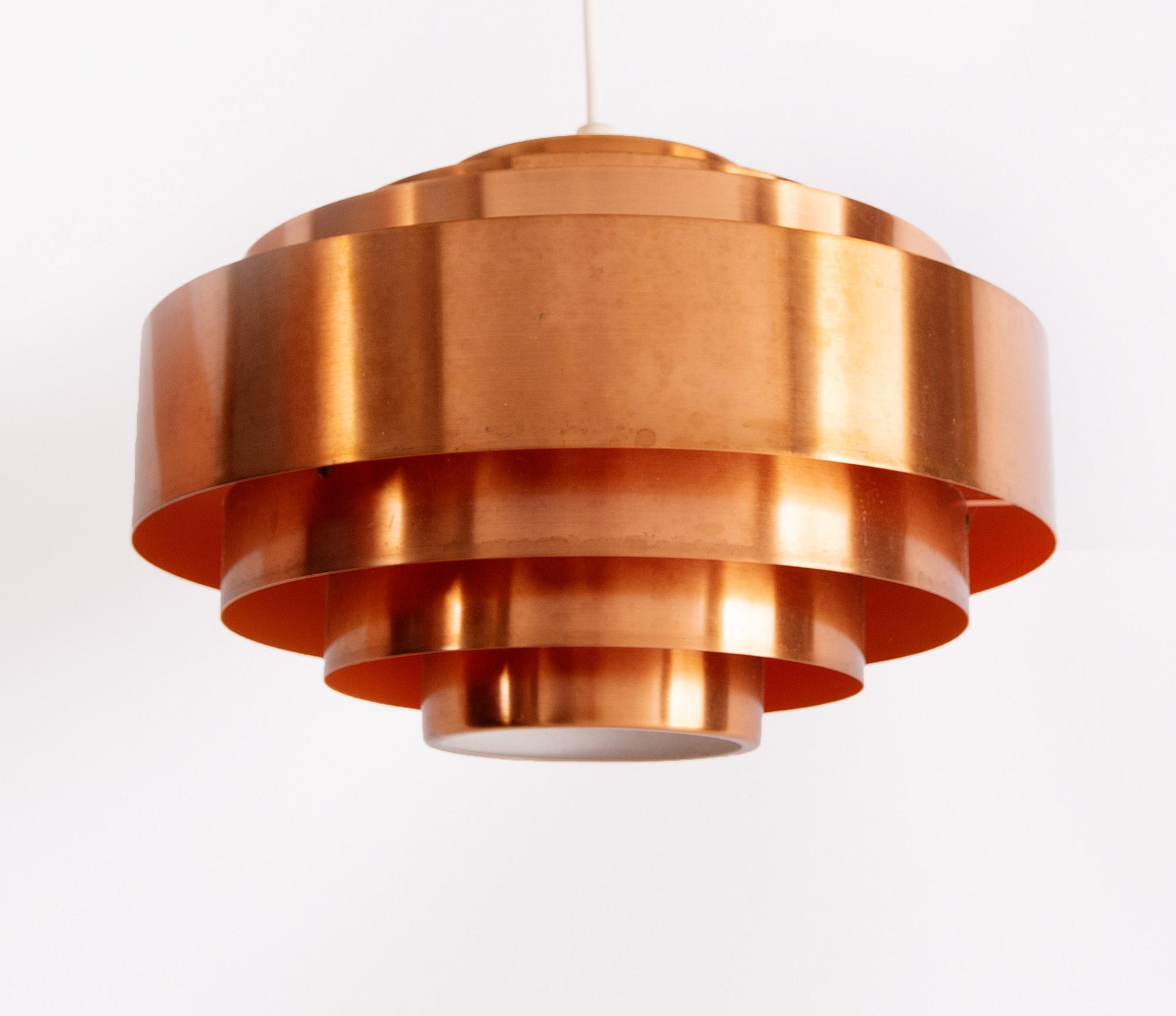 A copper ceiling lamp, by Fog & Mørup, Denmark, and a copper mirror, Markaryd.