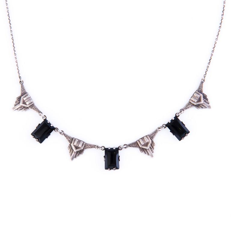 Four Art deco jewelry, ring, pendant necklace and earrings in silver.