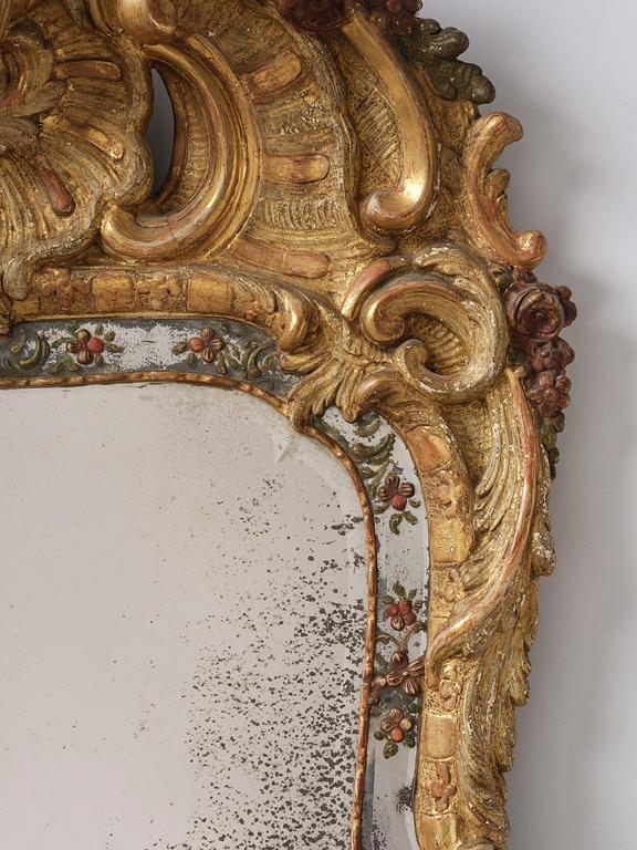 A Swedish giltwood and polychrome-painted Rococo mirror, later part of the 18th century.