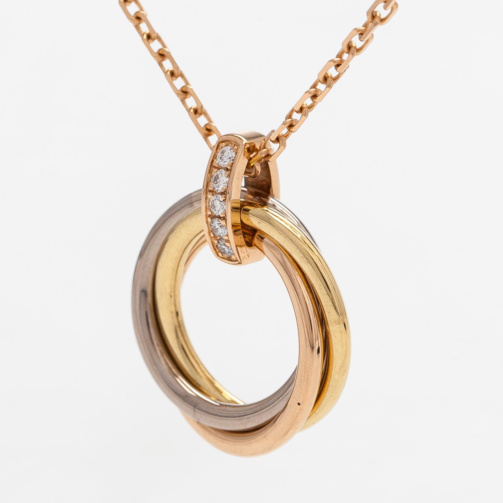 Cartier, an 18K gold 'Trinity Pendant' necklace with brilliant-cut diamonds.