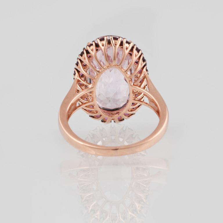 RING, 18K guld med ovalslipad kunzit ca 12.40 ct samt fasettslipade rosa safirer ca 1.15 ct. Vikt 7,2 gram.