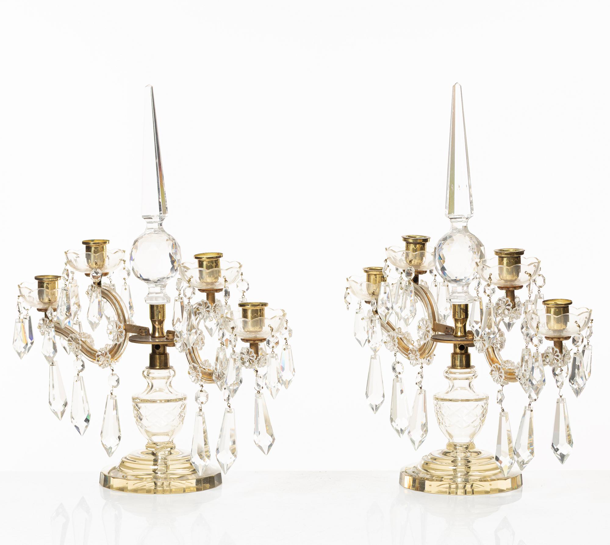 A pair of brass and glass canelabras, first half of the 20th century.