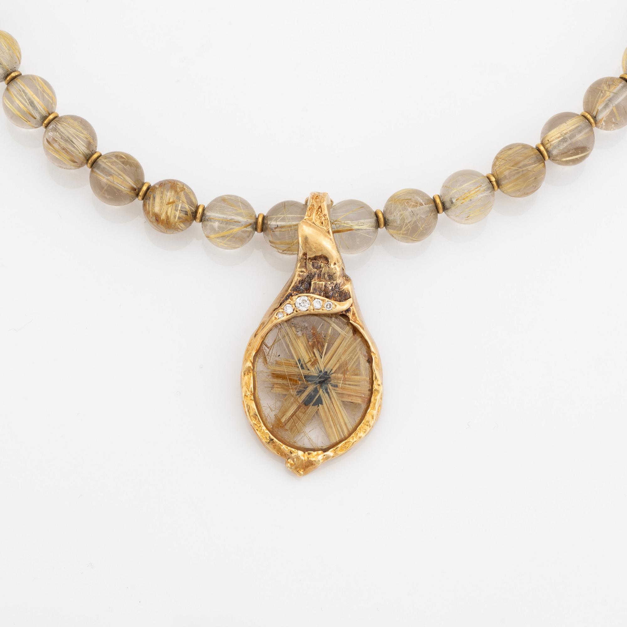 Arne Blomberg, pendant with chain, rutile quartz, gold and diamonds.