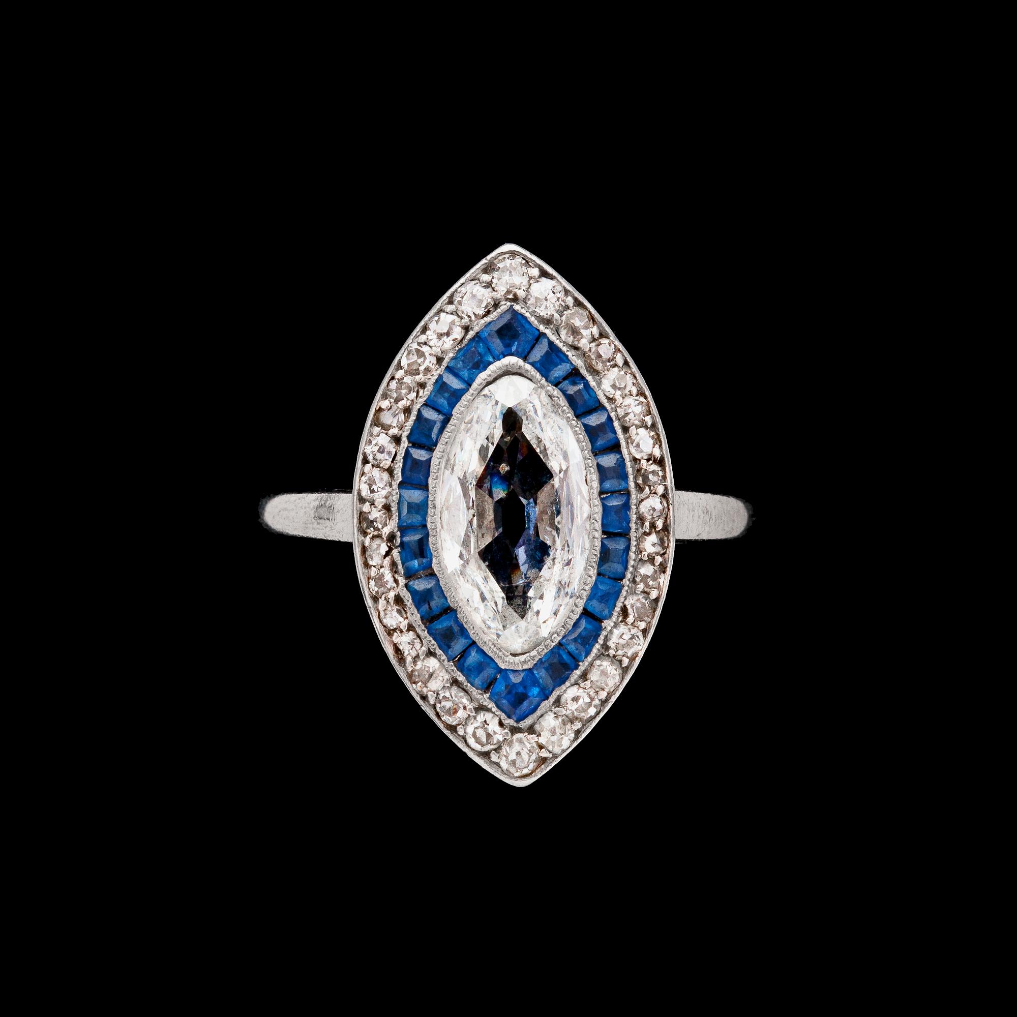A navette cut diamond, app. 1.20 cts, blue sapphire and brilliant cut diamond ring.