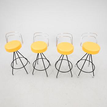 A 1970s bar and four stools.