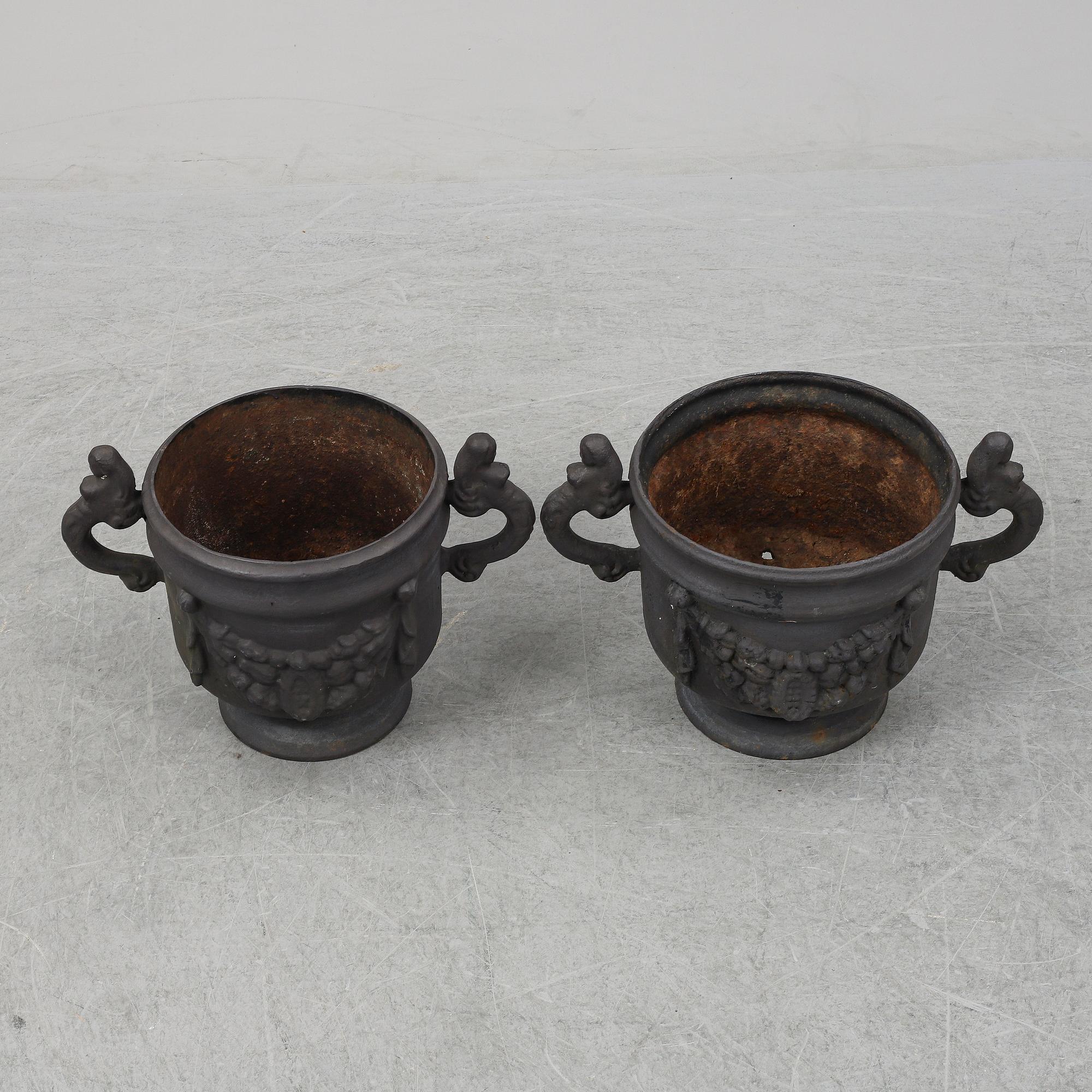 Two 20th Century cast iron flower pots.