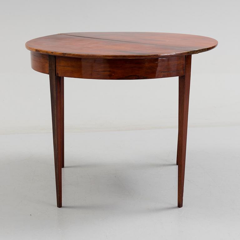 A first half od the 19th century game table veneered with mahogny.